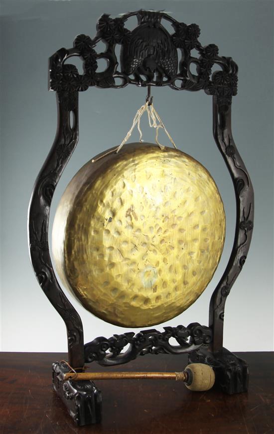 A Chinese hongmu framed brass dinner gong, c.1900, height 85cm width 55cm